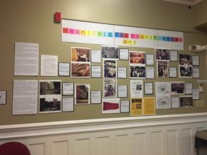 photo of exhibit wall including documents and photographs